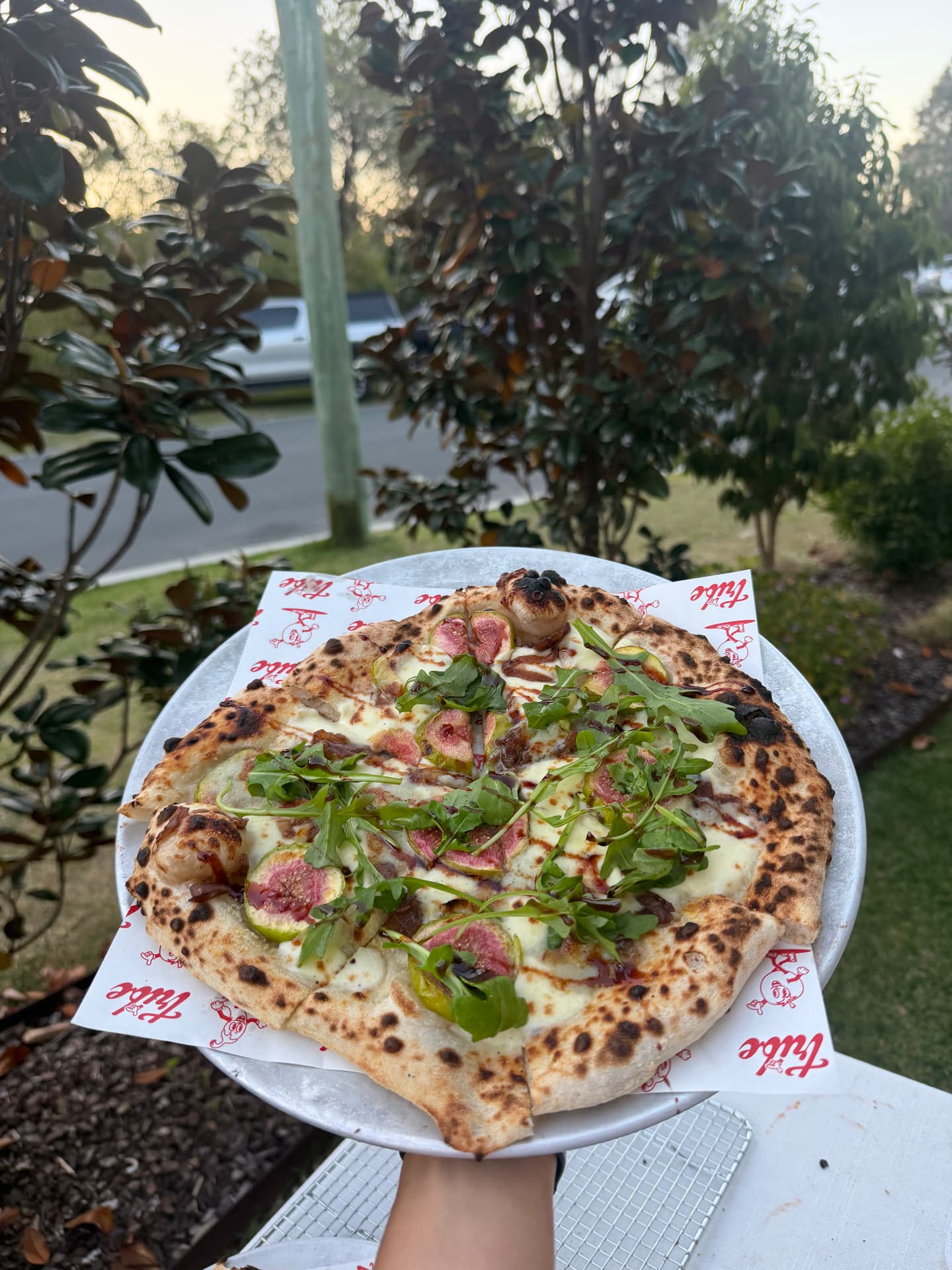 Fresh sourdough pizza topped with figs and rocket
